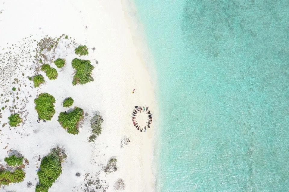 Aerial view of Maafushi turquoise lagoon and white sand beach in the Maldives